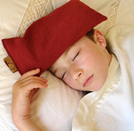 Cherry pit eye pillow resting over the eyes